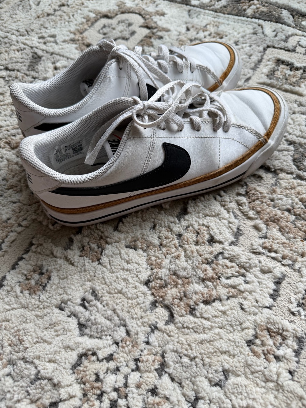 Nike Kids White Sneakers with Black Swoosh and Brown Accent